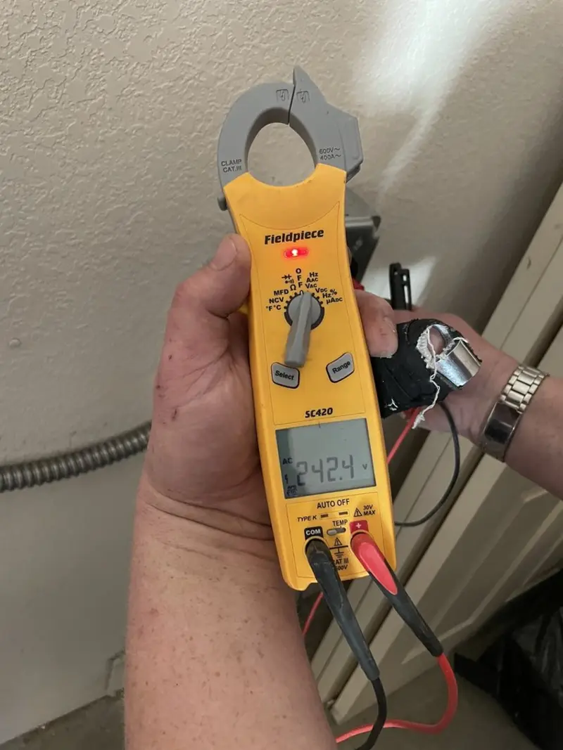 Voltage testing with clamp meter during Outlet Installation in Oak Grove